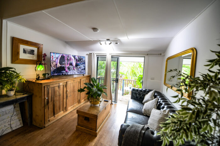 loungeroom flowing onto deck overlooking rainforest garden